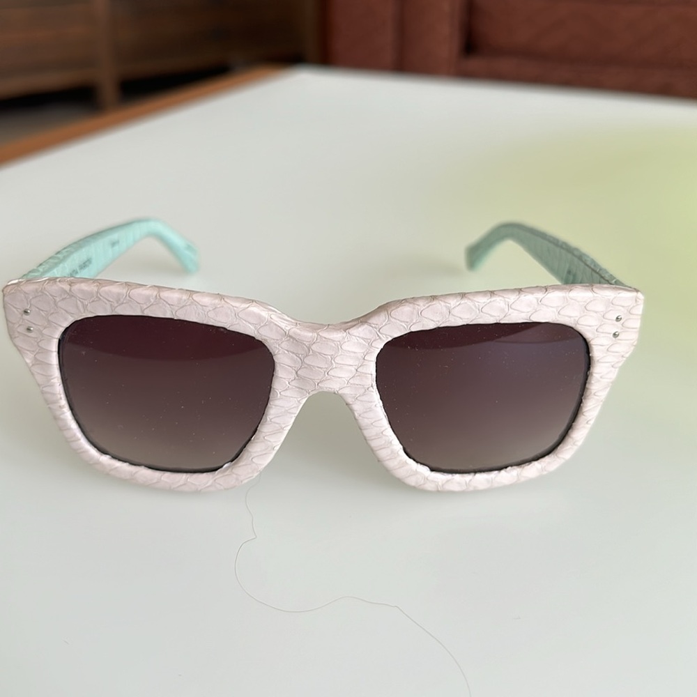 LINDA FARROW snakeskin sunglasses are a celebration of opulent materials.